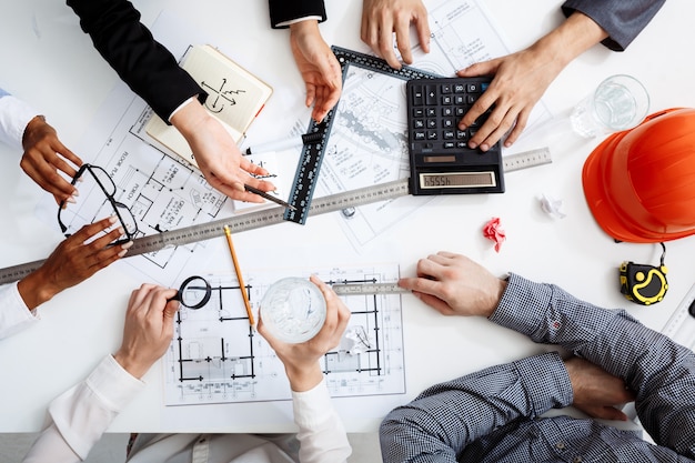 Free photo businessmen hands on white table with documents and drafts