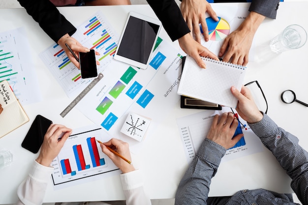 Free photo businessmen hands on white table with documents and drafts