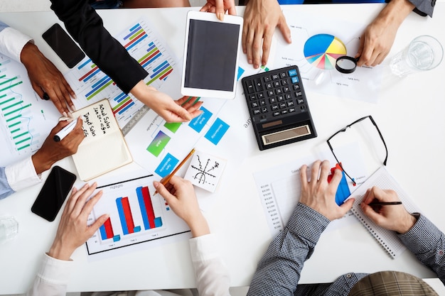  businessmen hands on white table with documents and drafts