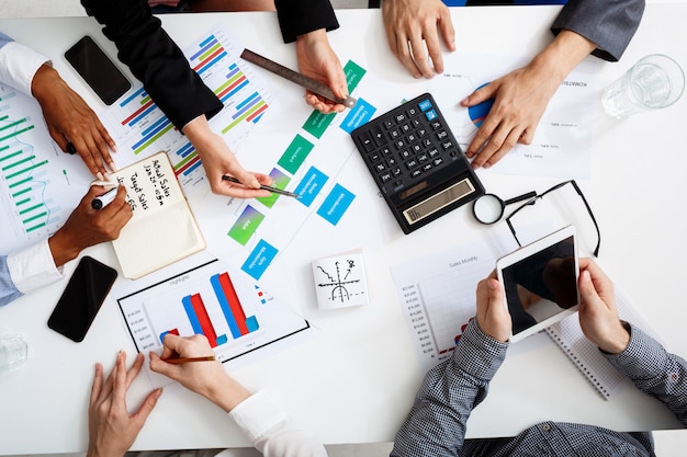  businessmen hands on white table with documents and drafts