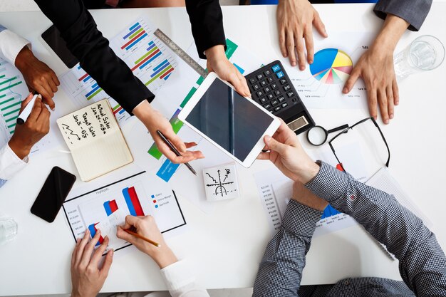  businessmen hands on white table with documents and drafts