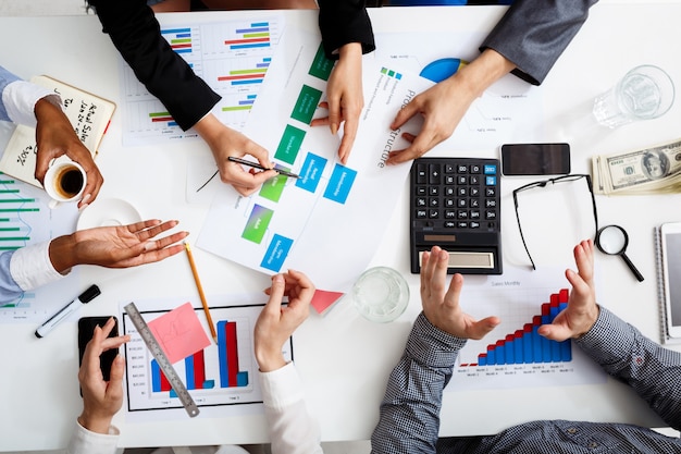  businessmen hands on white table with documents and drafts