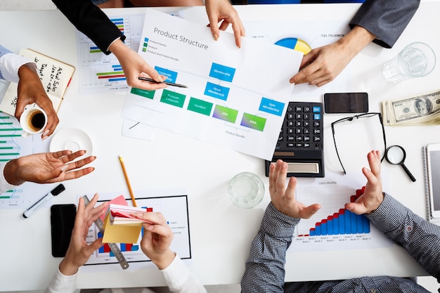  businessmen hands on white table with documents and drafts