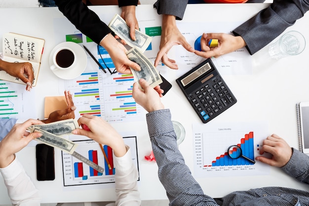  businessmen hands on white table with documents and drafts