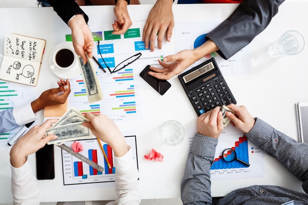  businessmen hands on white table with documents and drafts