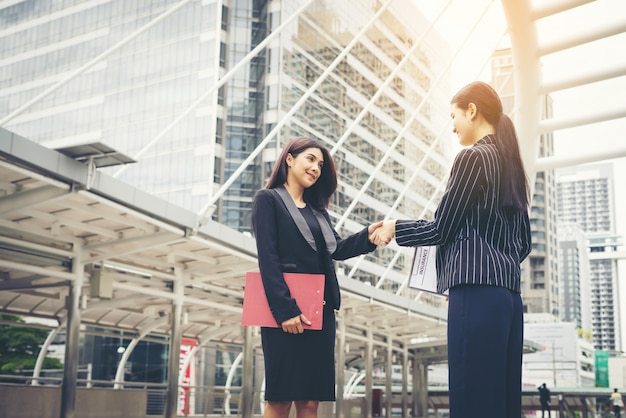 Free photo businessmen handshake with workmate,handshake business partner work deal together.