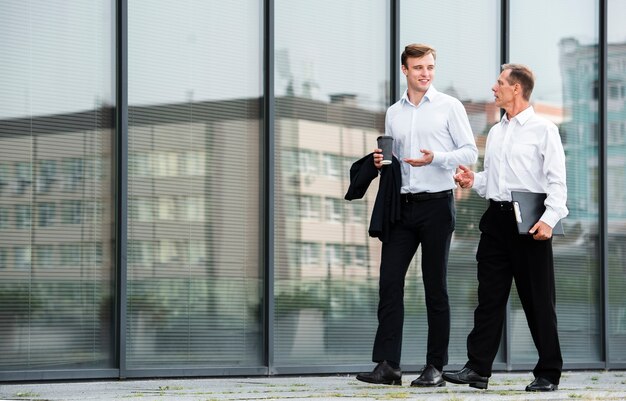 Businessmen having a conversation while walking