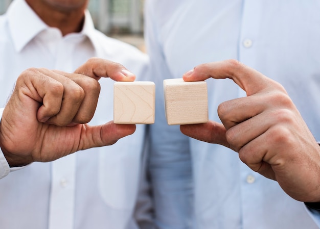 Businessmen holding cubes close-up