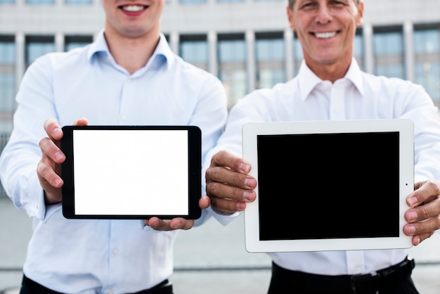 Businessmen holding tablets mock-up