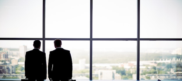 Businessmen looking through the window