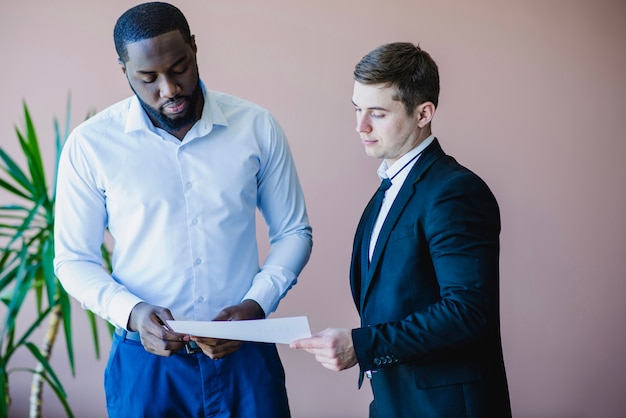 Businessmen reading document