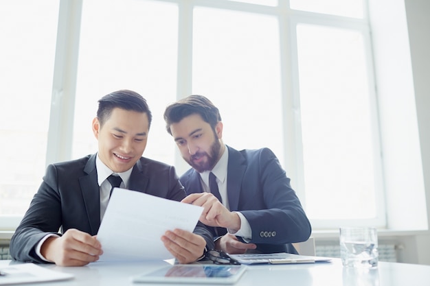 Businessmen reviewing the summary