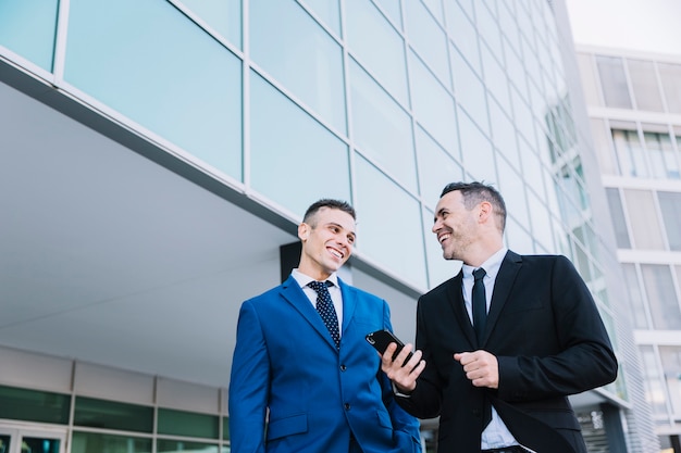 Free photo businessmen talking outside