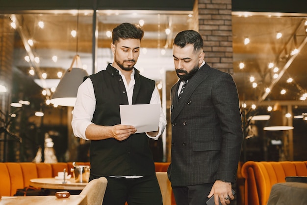 Businessmen working in a cafe