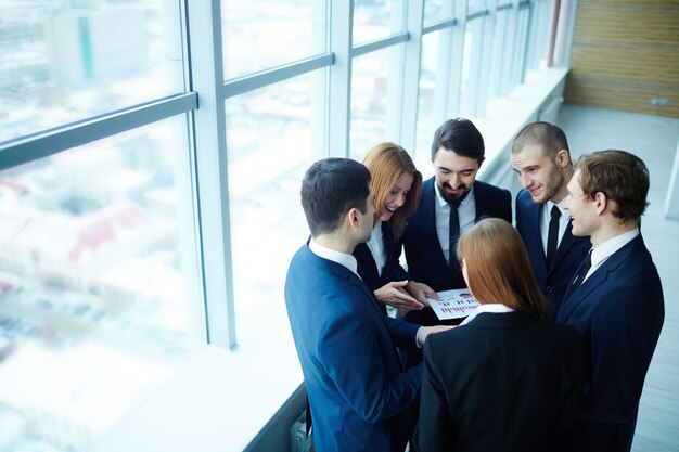 Businesspeople around a report