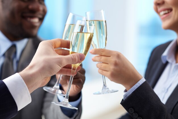 Businesspeople celebrating the agreement with champagne