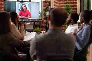 Free photo businesspeople discussing company partnership with remote leader working at marketing presentation during online videocall meeting conference in startup office. business call on computer monitor