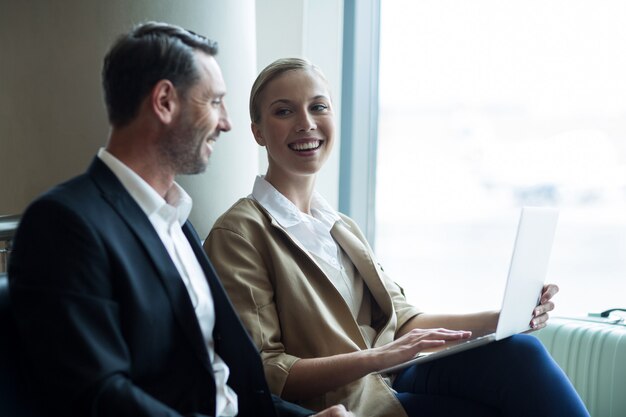 Businesspeople discussing over laptop