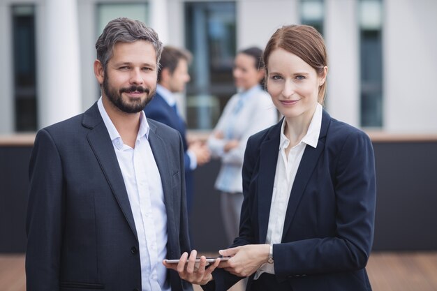 Businesspeople holding digital tablet