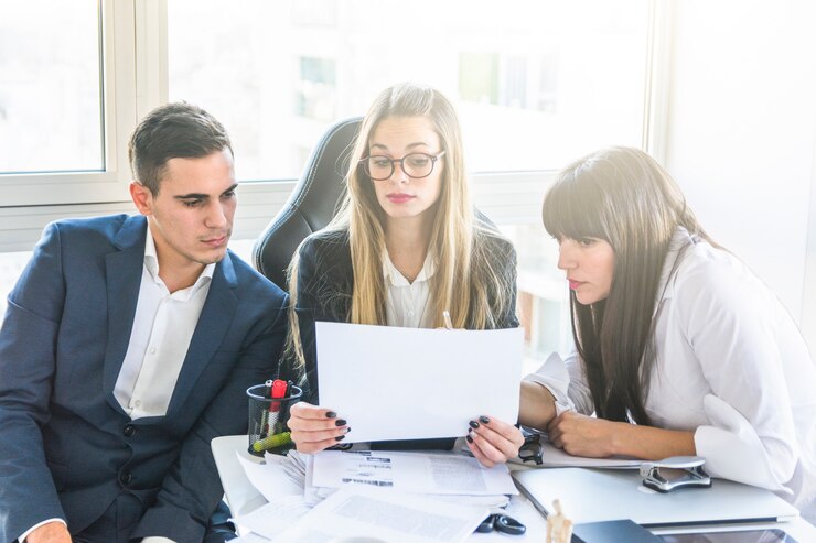Free Photo businesspeople looking at document in office