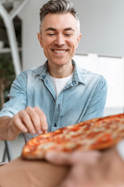 Businesspeople on lunch break eating pizza