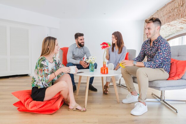 Businesspeople relaxing in office with coffee