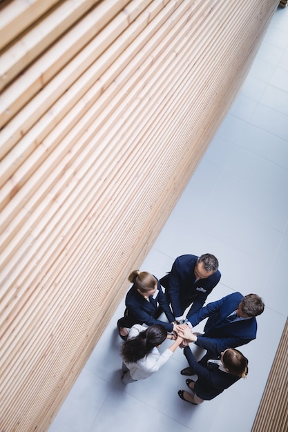 Businesspeople stacking hands together