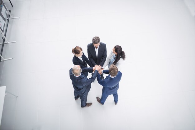 Businesspeople stacking hands together