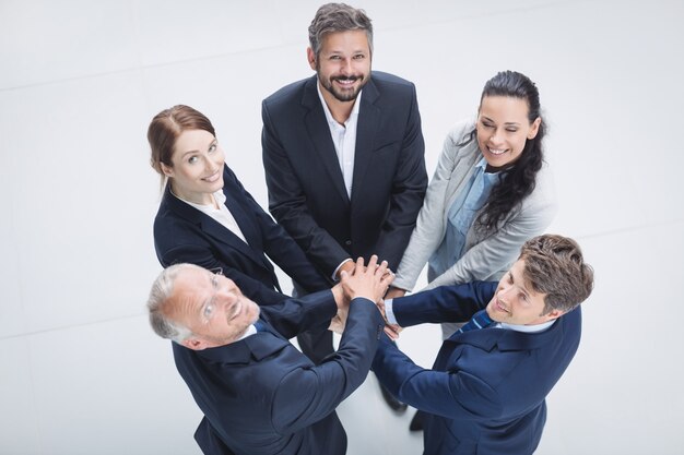 Businesspeople stacking hands together
