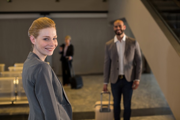 Businesspeople walking with luggage