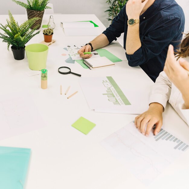 Businesspeople with graph and energy saving concept on paper over desk