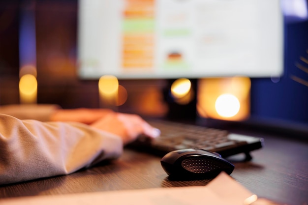 Businesswoman analyzing financial growth report typing company strategy on computer keyboard Executive manager working late at night at marketing project in startup office Close up