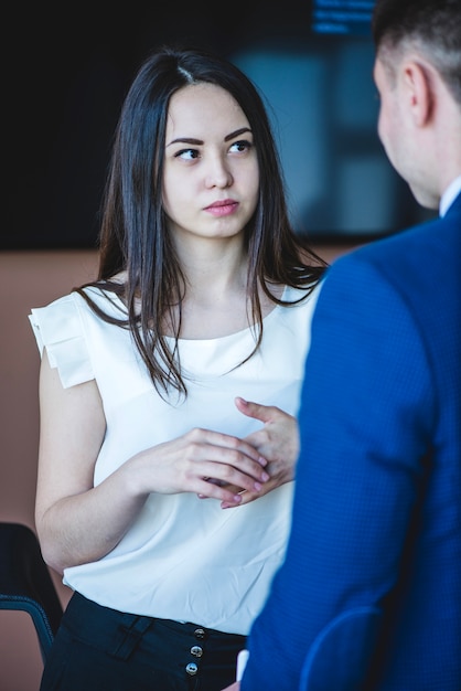 Businesswoman and back of businessman