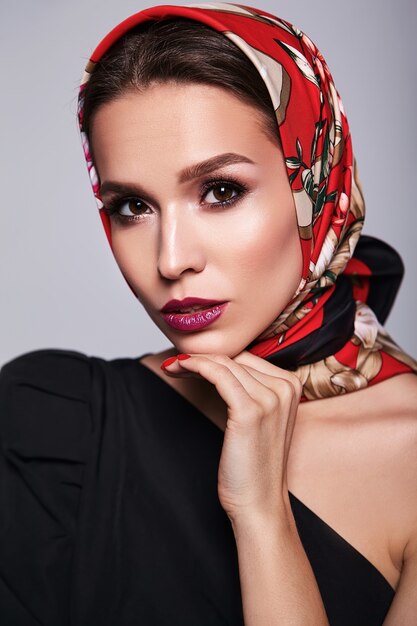 businesswoman in black dress with evening makeup and colorful lips in red shawl