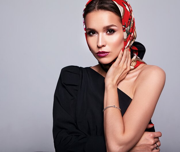 businesswoman in black dress with evening makeup and colorful lips in red shawl