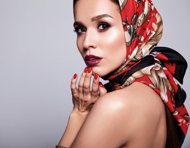 businesswoman in black dress with evening makeup and colorful lips in red shawl