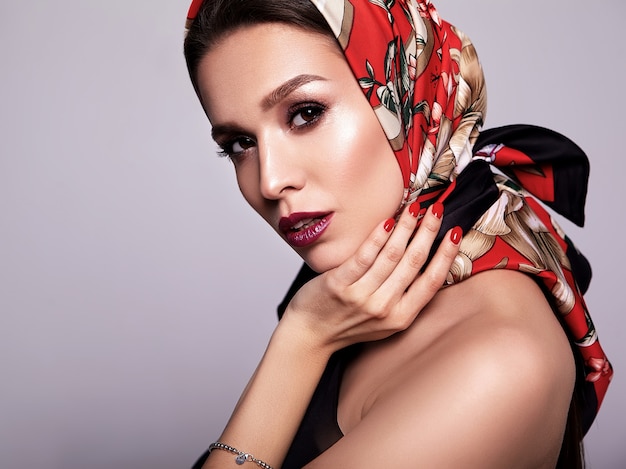 businesswoman in black dress with evening makeup and colorful lips in red shawl