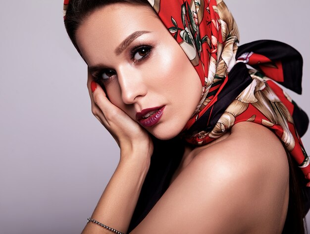businesswoman in black dress with evening makeup and colorful lips in red shawl