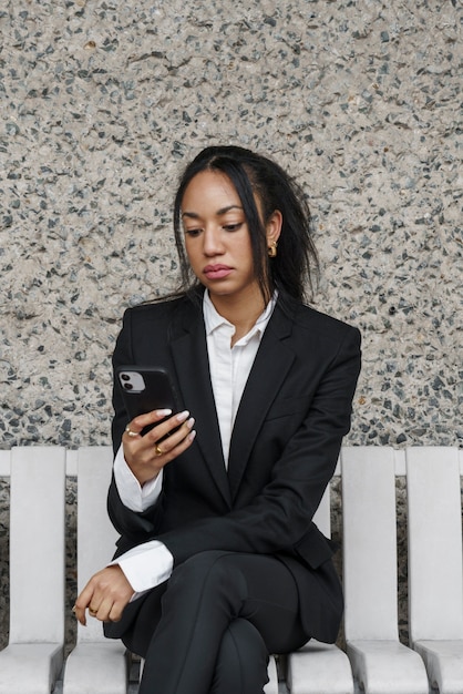 Businesswoman checking chat app on her smartphone