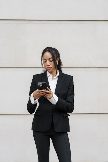 Businesswoman checking smartphone