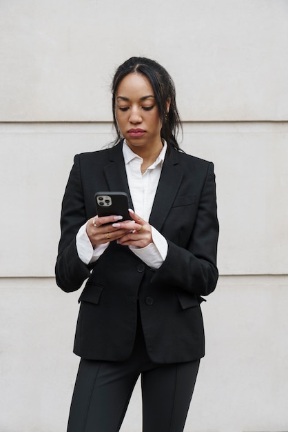 Businesswoman checking smartphone