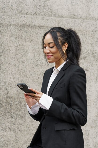 Businesswoman checking smartphone