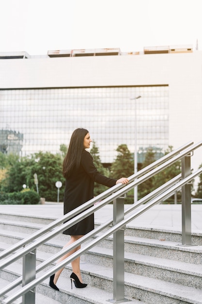 Businesswoman climbing staircase