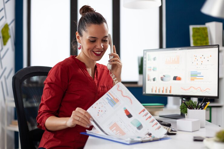 Free Photo businesswoman in company office checking finaicial statistics