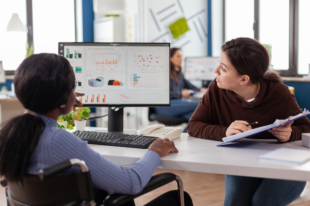 Businesswoman discussing with disabled woman