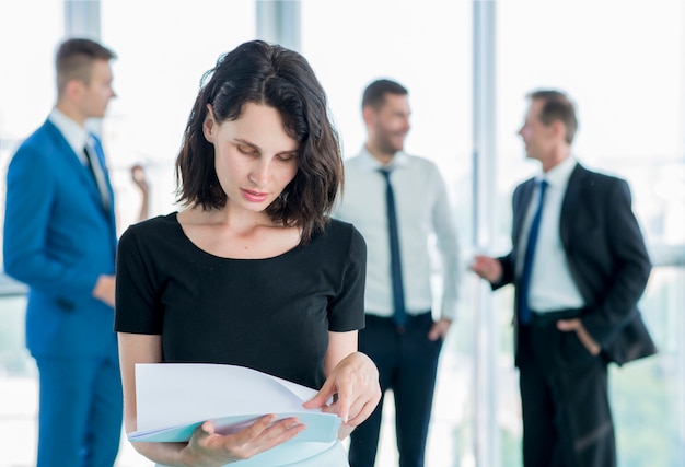 Businesswoman examining documents at workplace