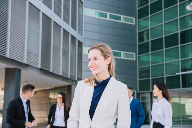 Businesswoman in front of business people