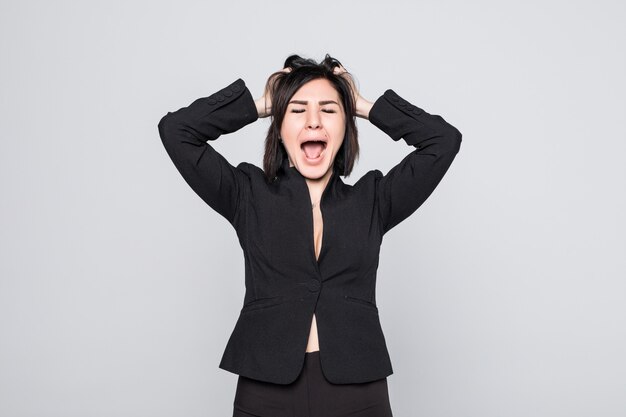 Businesswoman frustrated and stressed pulling her hair isolated on white