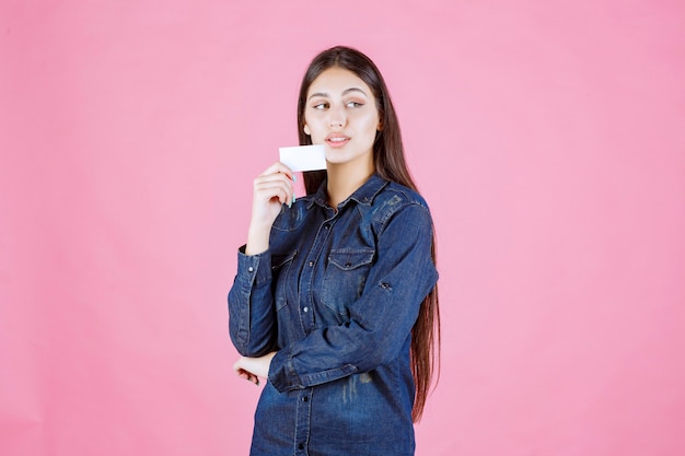 Businesswoman holding and presenting her new business card