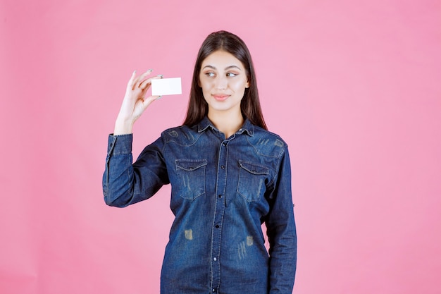 Businesswoman holding and presenting her new business card